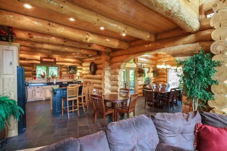 Open kitchen and dining area with log beams
