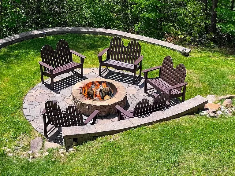 Fire pit with Adirondack chairs in the yard