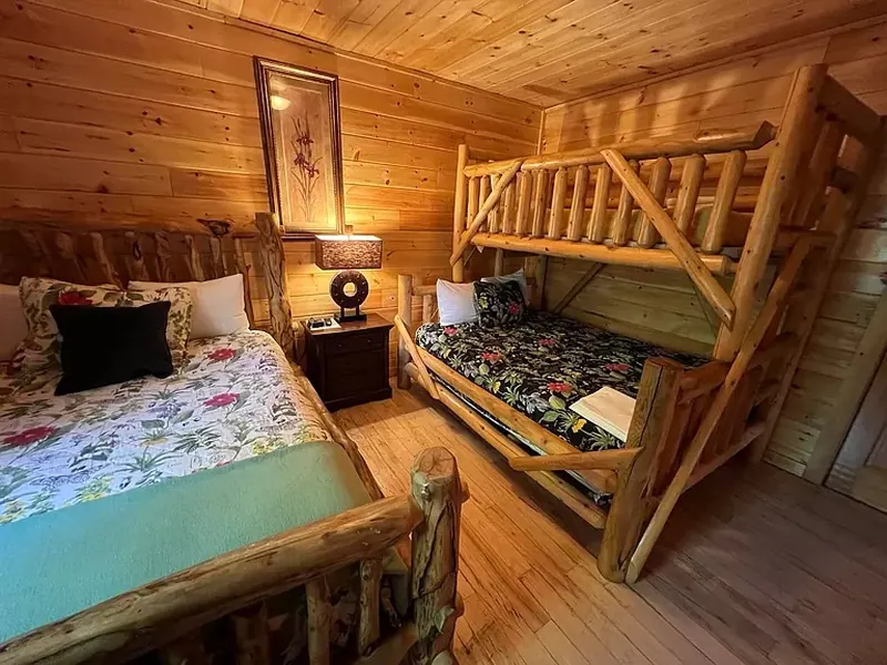 Family bedroom that can sleep five, with full bath outside bedroom door.